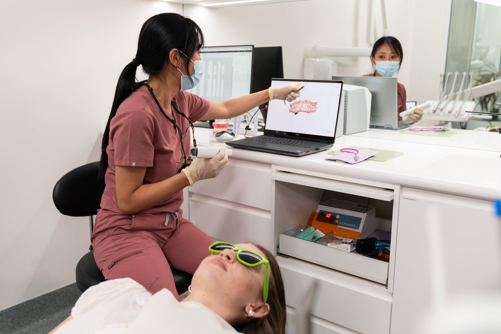 Dentist showing a patient their digital scan on a laptop