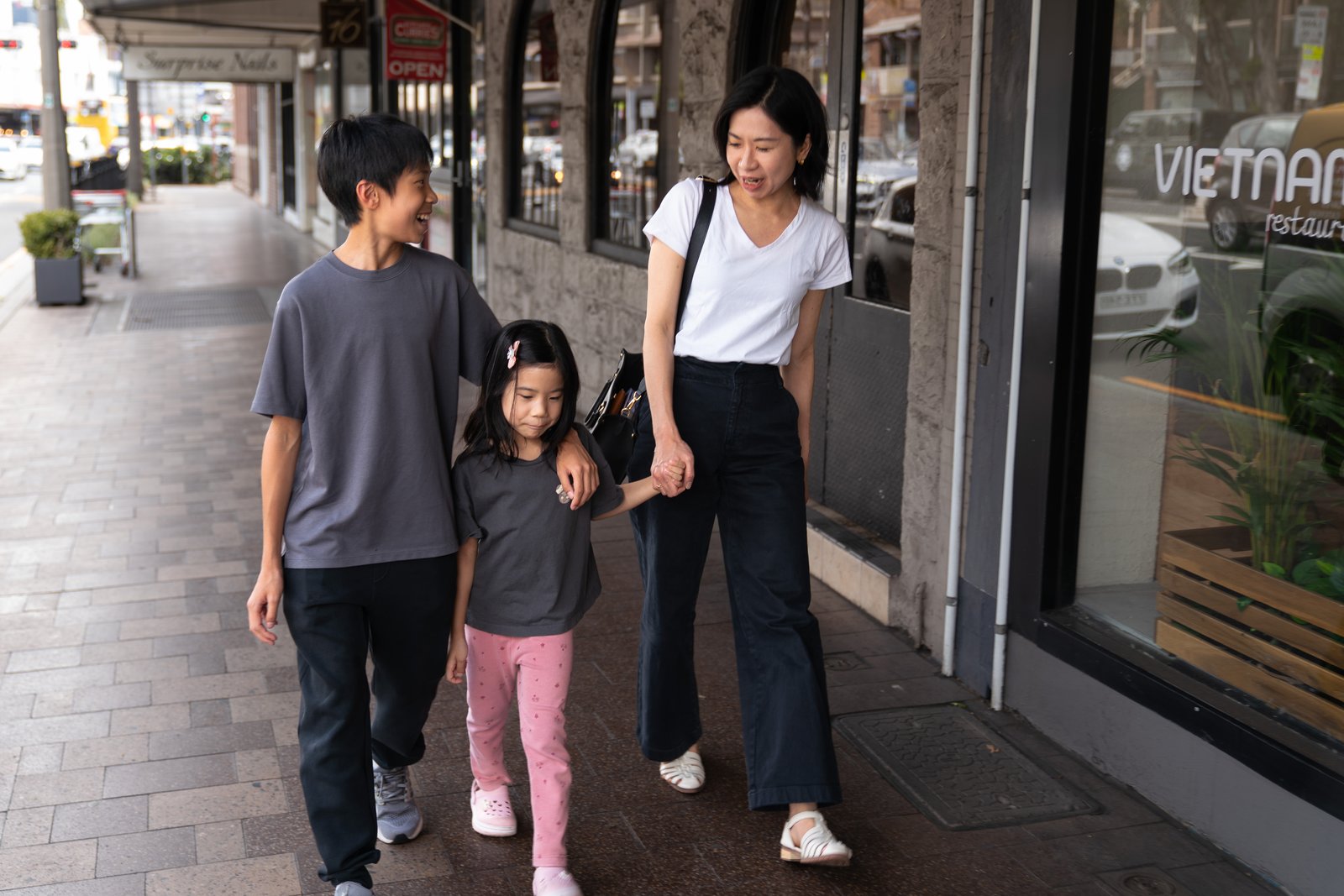 A family walking along Military Road in Neutral Bay